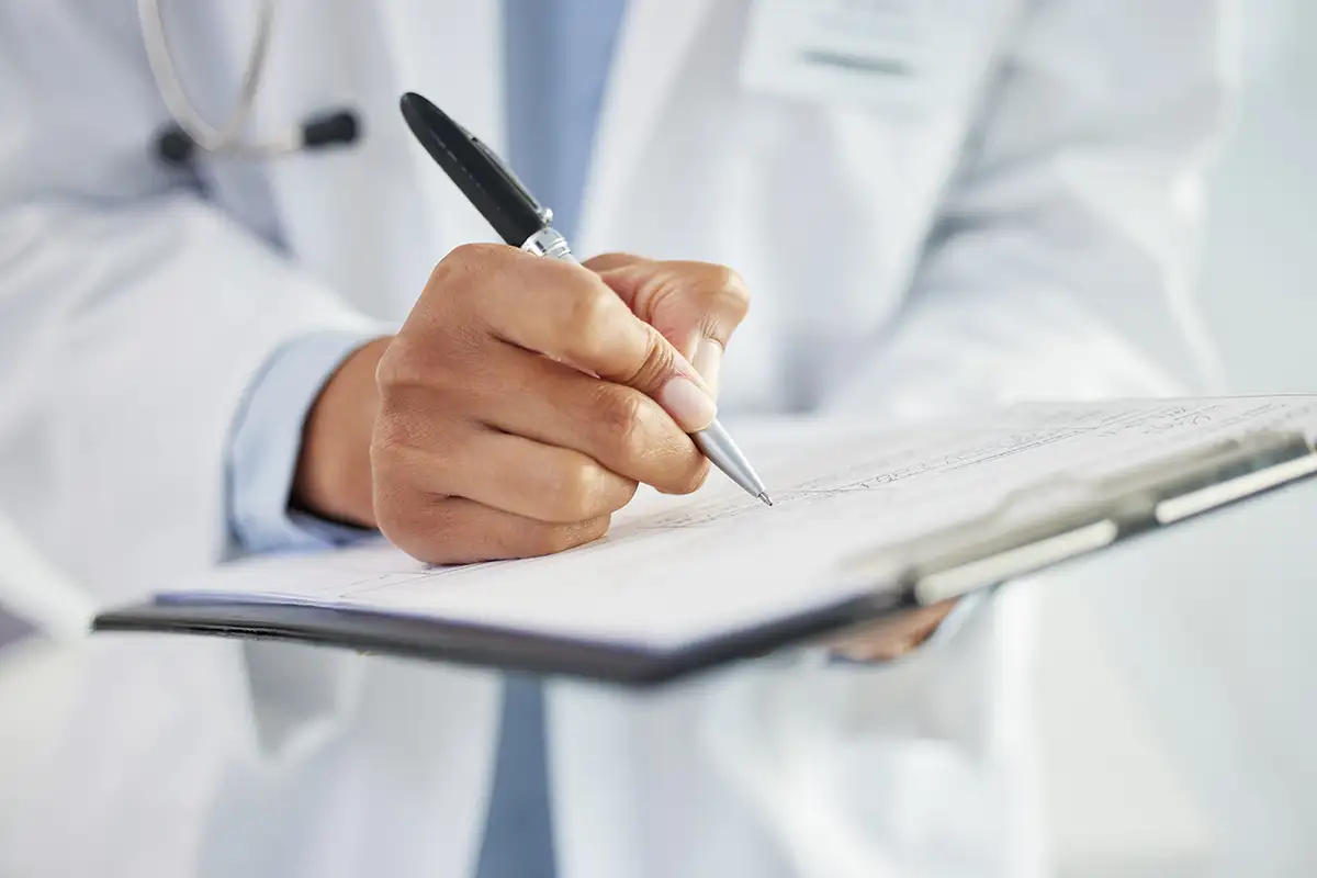 A dentist writing a prescription